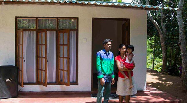 A Family with Their New House Built by Staff of Mahaweli Reach Hotel